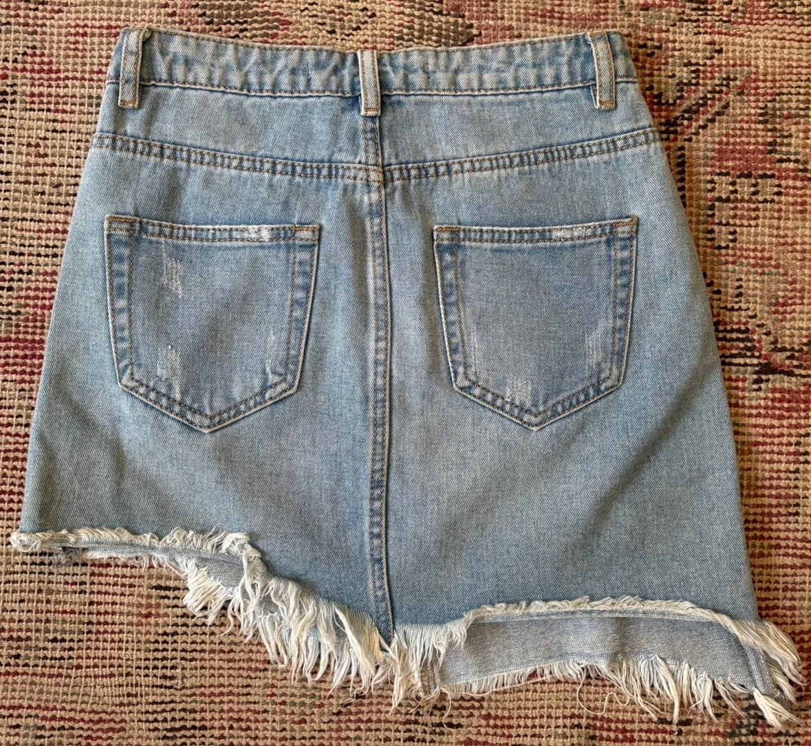 Farafallina asymmetrical denim skirt with gold studs and a raw hem.  - Image 2