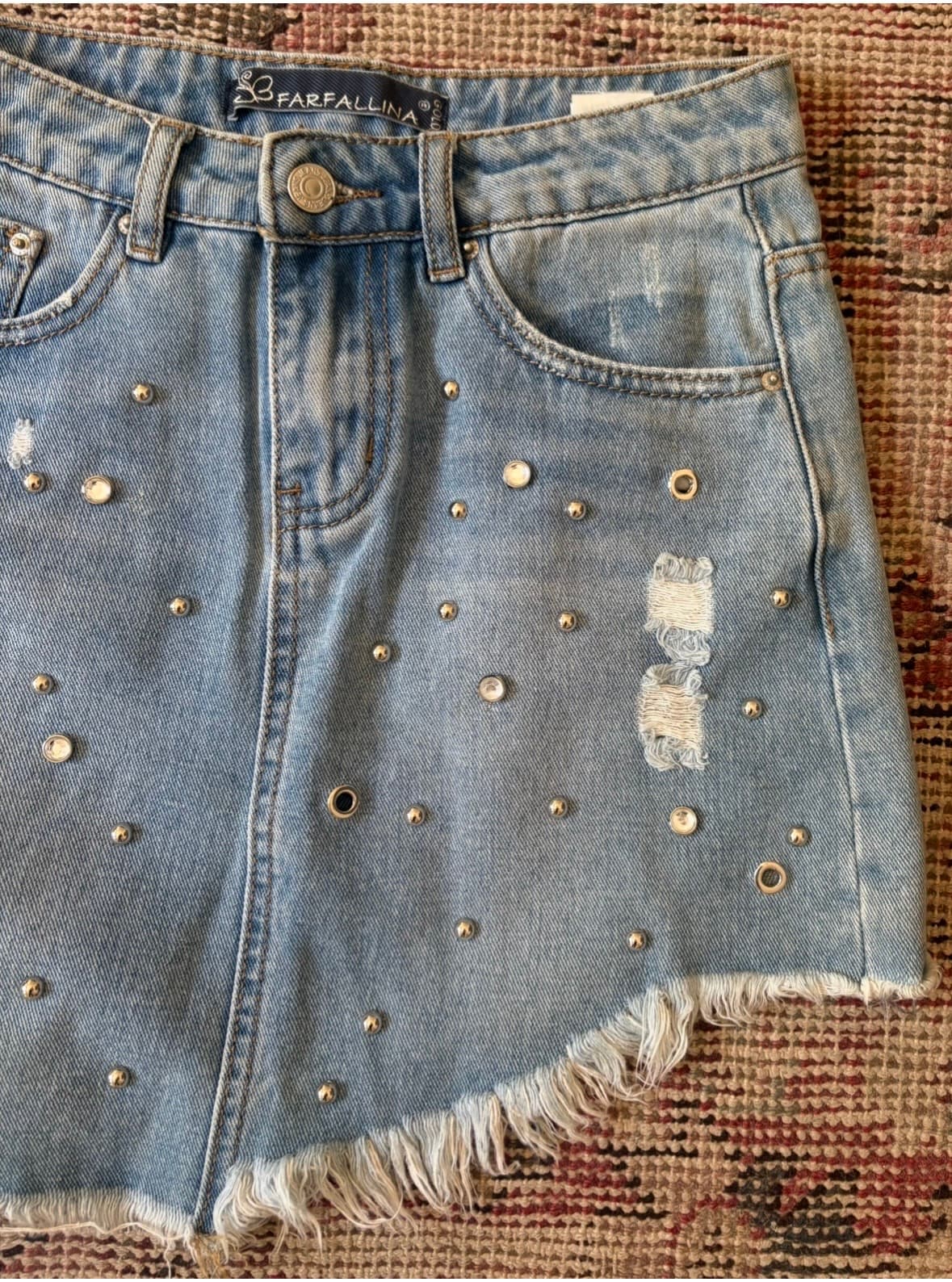 Farafallina asymmetrical denim skirt with gold studs and a raw hem.  - Image 3