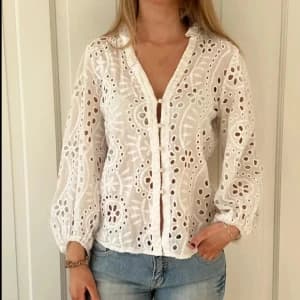White Cutwork anglaise Blouse with baby buttons and slight puff shoulder . Size M 